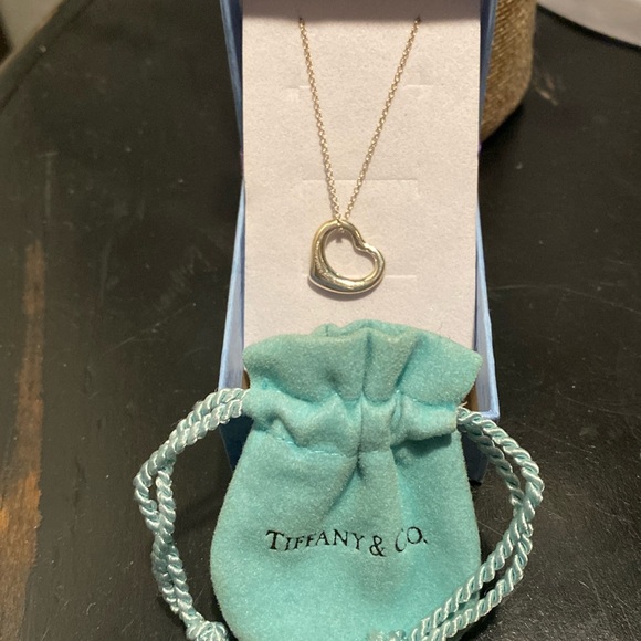 Tiffany & Co. Jewelry - Tiffany & Co small heart charm. Comes with small dust bag and Tiffany & Co chain